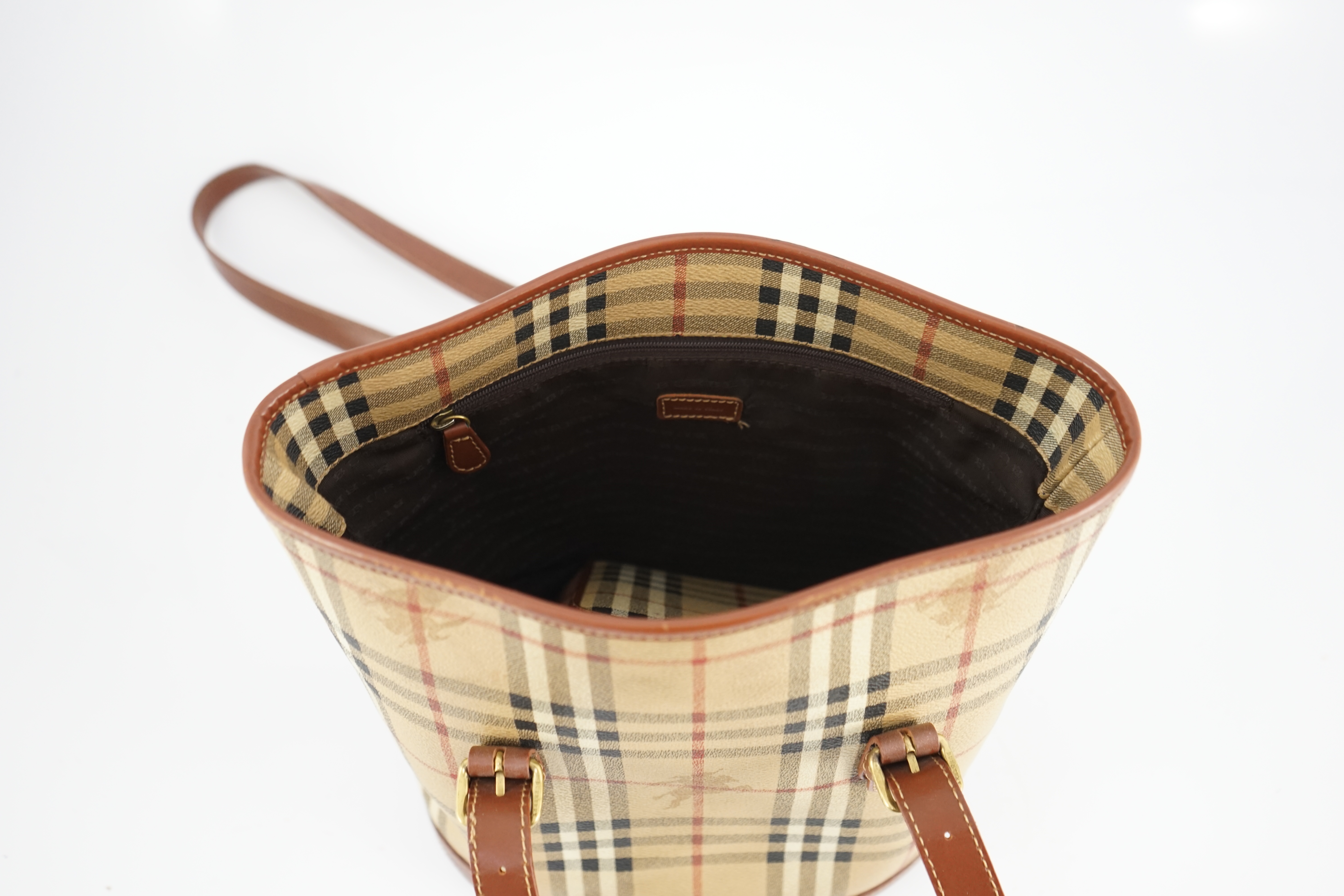 A Burberry Beige/Brown Haymarket coated canvas and leather bucket bag, wallet, cosmetic pouch and small zip case Bag: width 28cm, depth16cm, height 28cm. Wallet: width 20cm, depth 2cm, height 10cm. Cosmetic pouch: width1